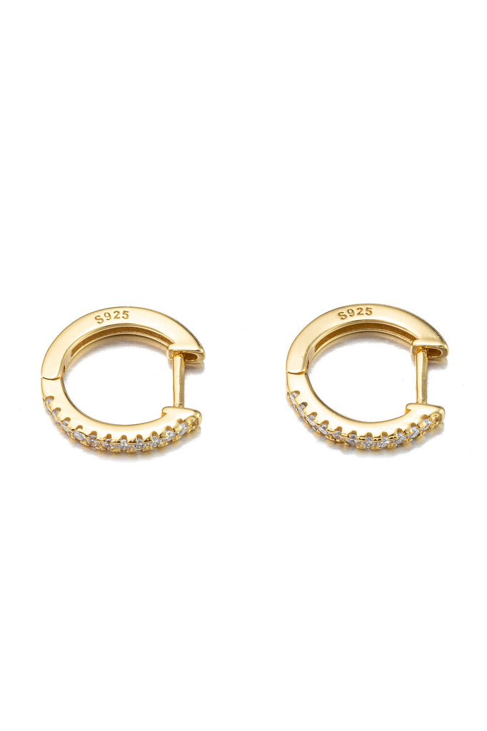 Gold tone sterling silver huggie earrings studded with CZ crystals.