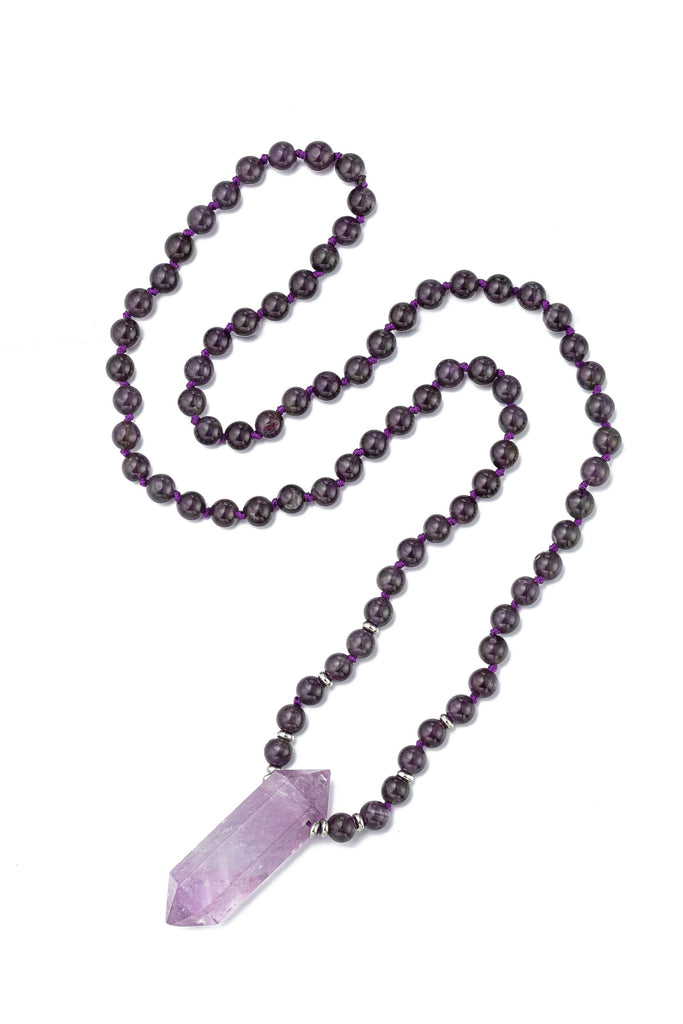 Handmade amethyst quartz crystal pendant on a beaded necklace. 