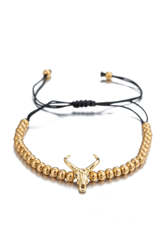 Titanium beaded bracelet with a brass skull head pendant.