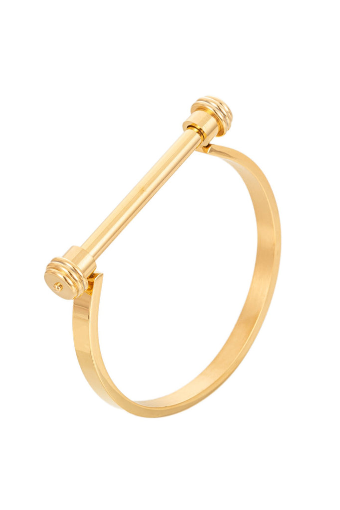 Gold tone titanium screw cuff bracelet. 