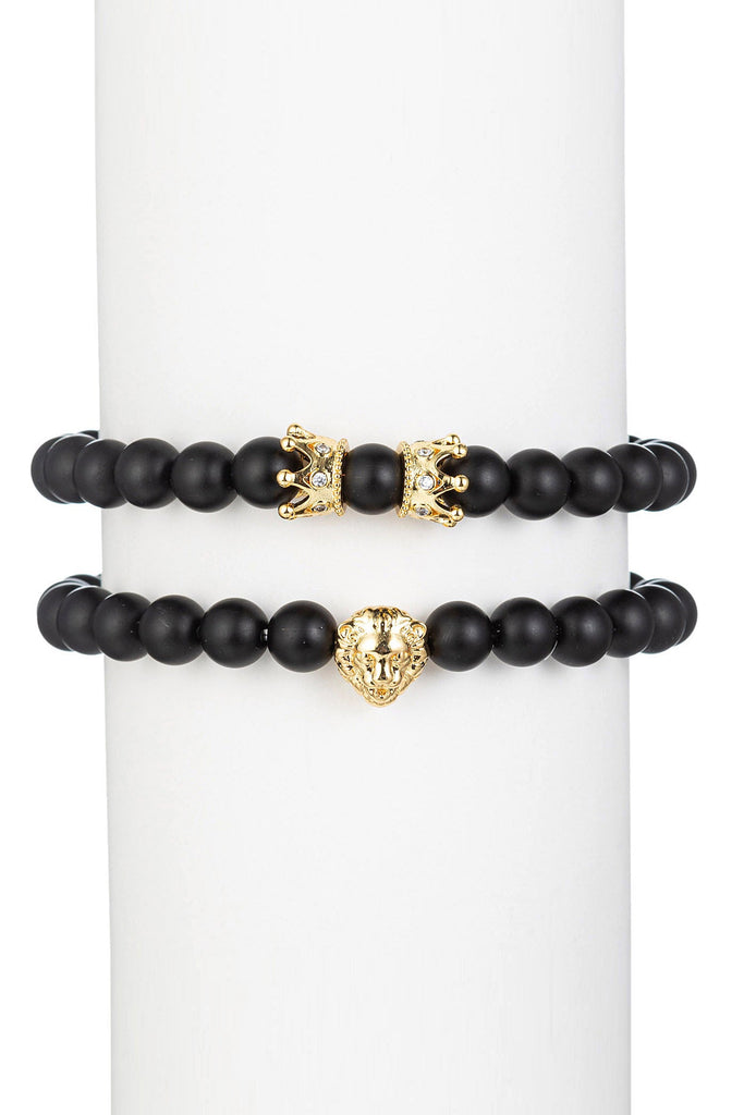 Gold titanium lion head pendant on a black lava beaded bracelet.